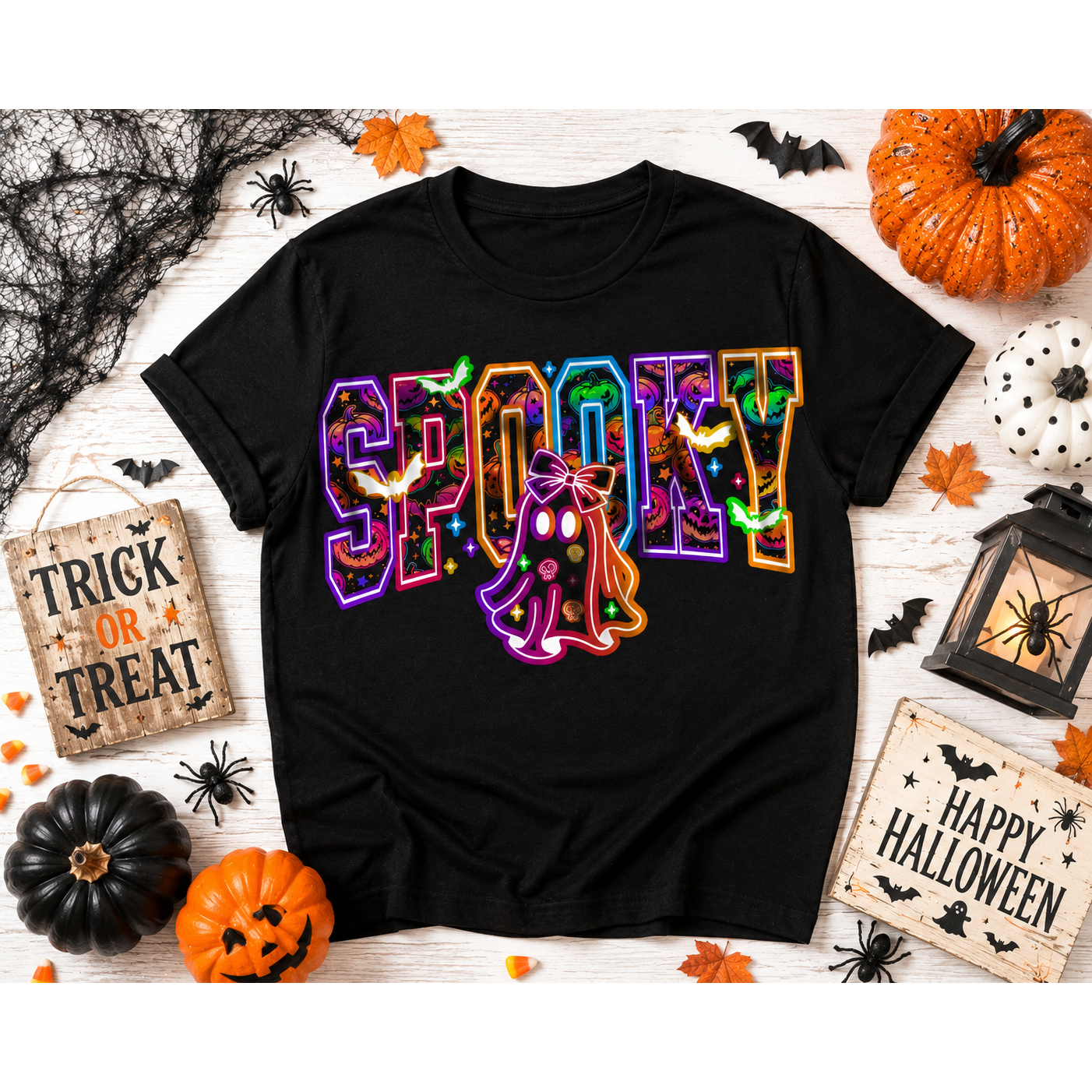 Black Halloween hoodie featuring a colorful SPOOKY graphic with pumpkins, bats, candy, and a trick-or-treating ghost.