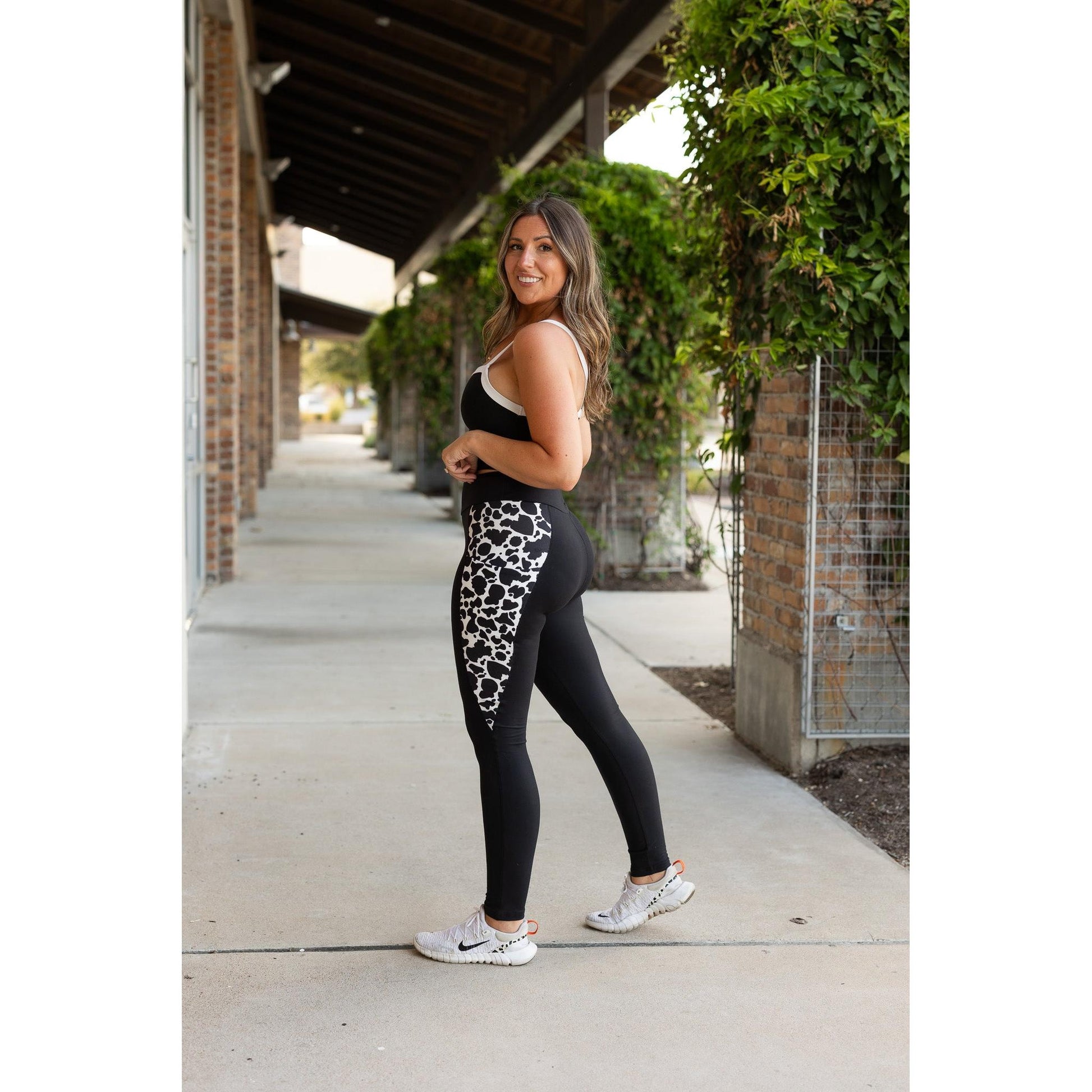 Julia Rose Carolina Cow Print Panel Leggings women’s boutique leggings front view, Woman wearing Julia Rose Carolina leggings with cow print panel detail
